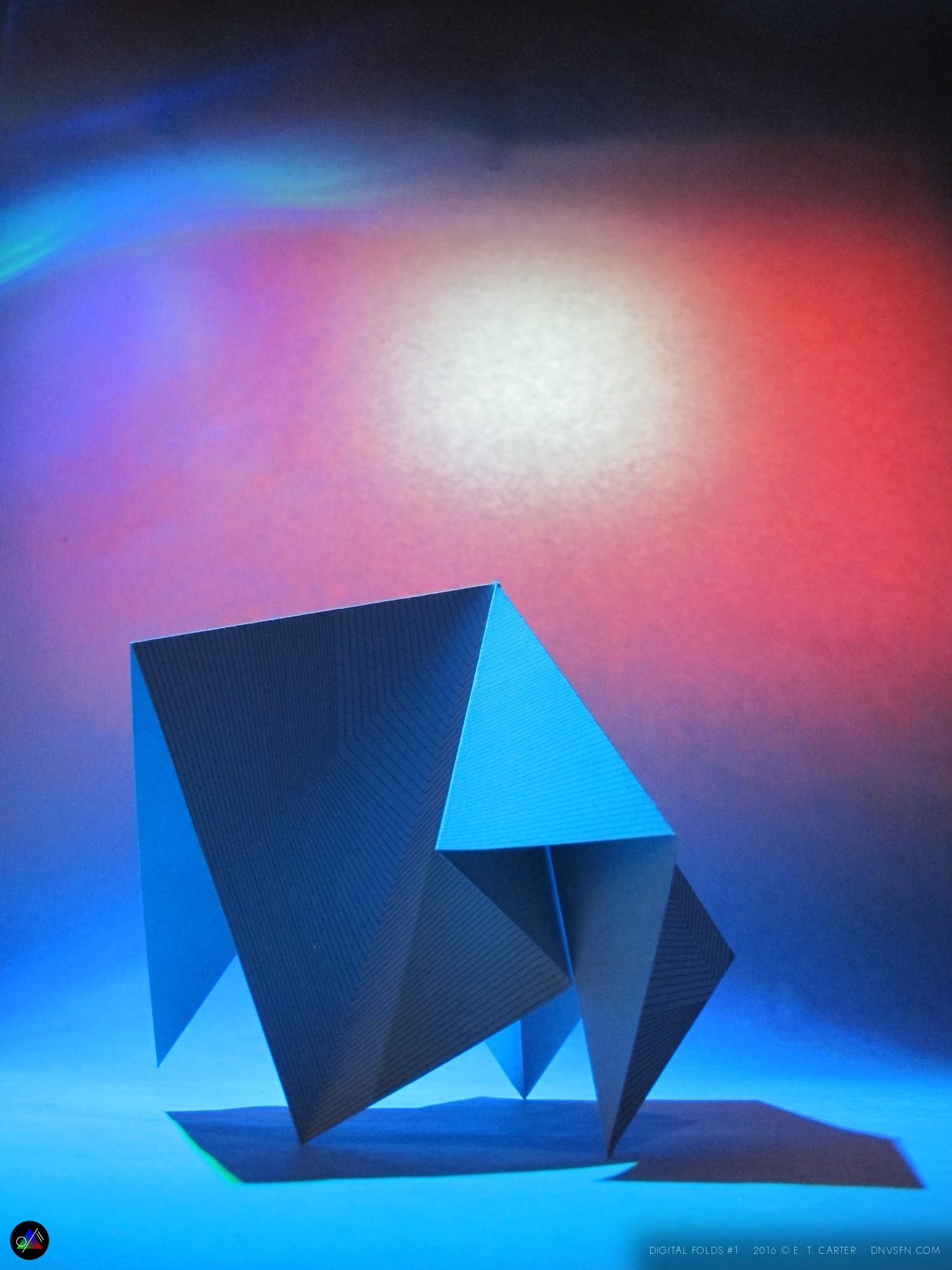 Blue faceted fold, red glow.