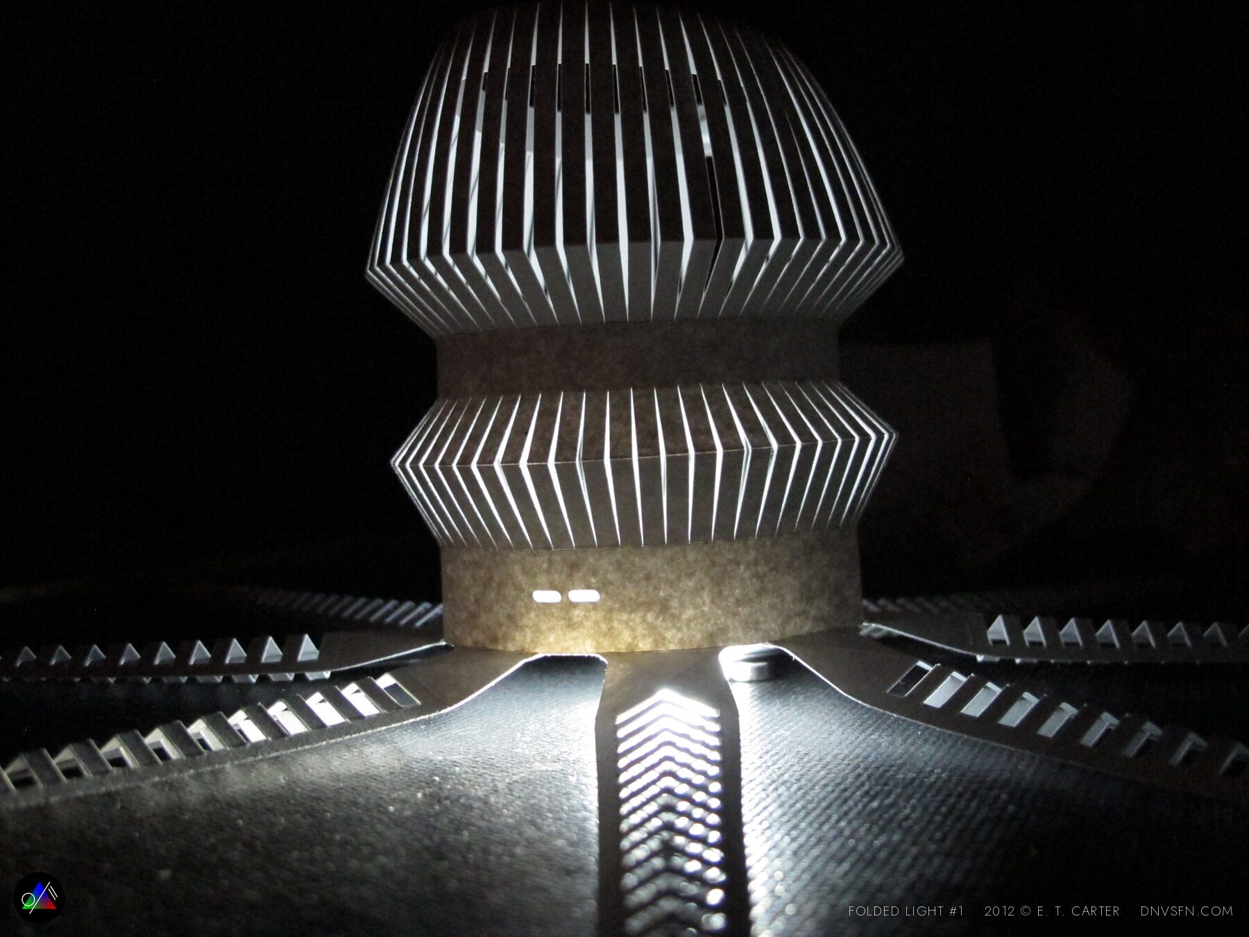 Folded sunburst, lit on black.