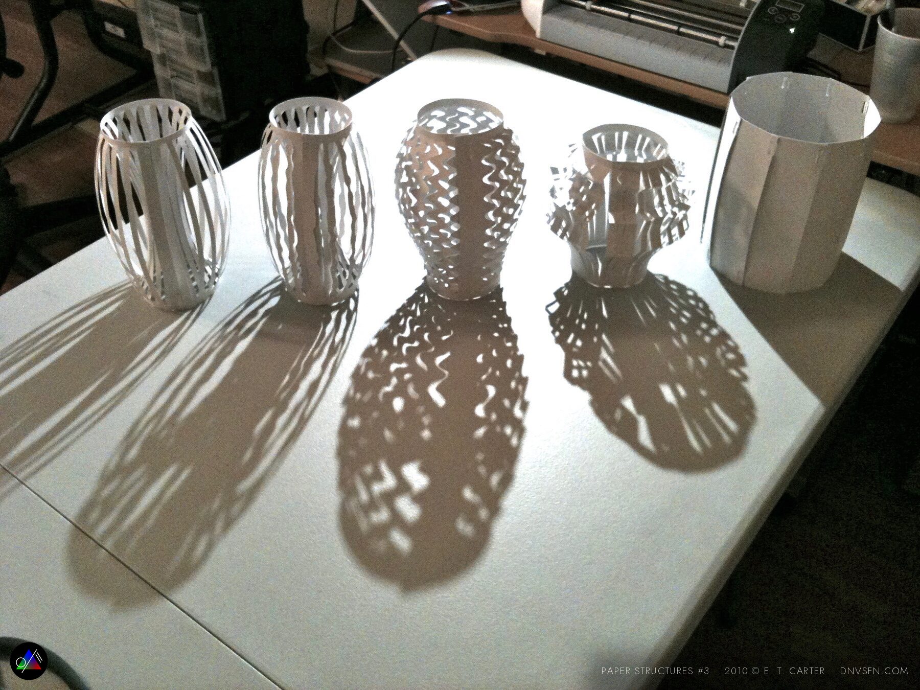 Cylinders casting long shadows.